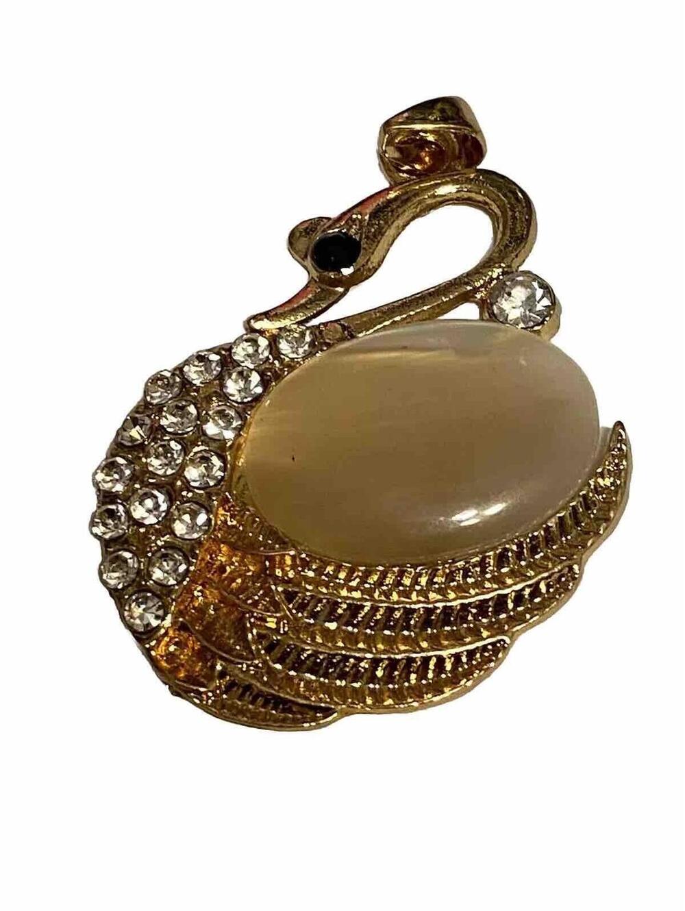 pendant swan  goldtone with faux crystals and black eye gem. No Chain.